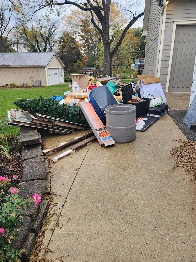 Dumpster being loaded with debris for Estate Cleanout Dumpster Rental in Elmsford